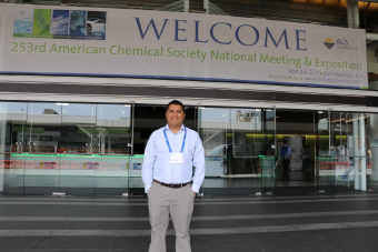 Dr. Bishnu Dhakal standing in fornt of the welcome sign of the 253rd American Chemical Society National Meeting & Exposition