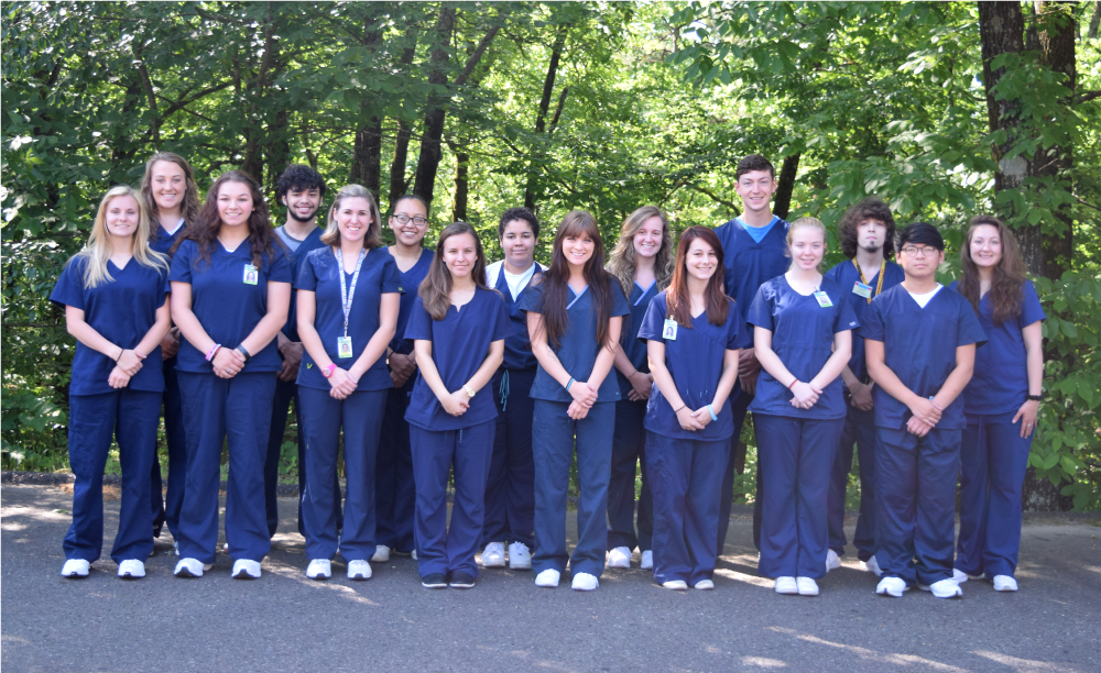 NPTC Medical Students, dressed in scrubs, standing for a group photo.
