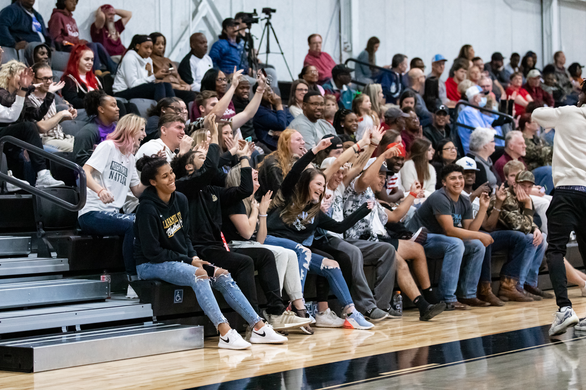 Students in the stands at a game cheering