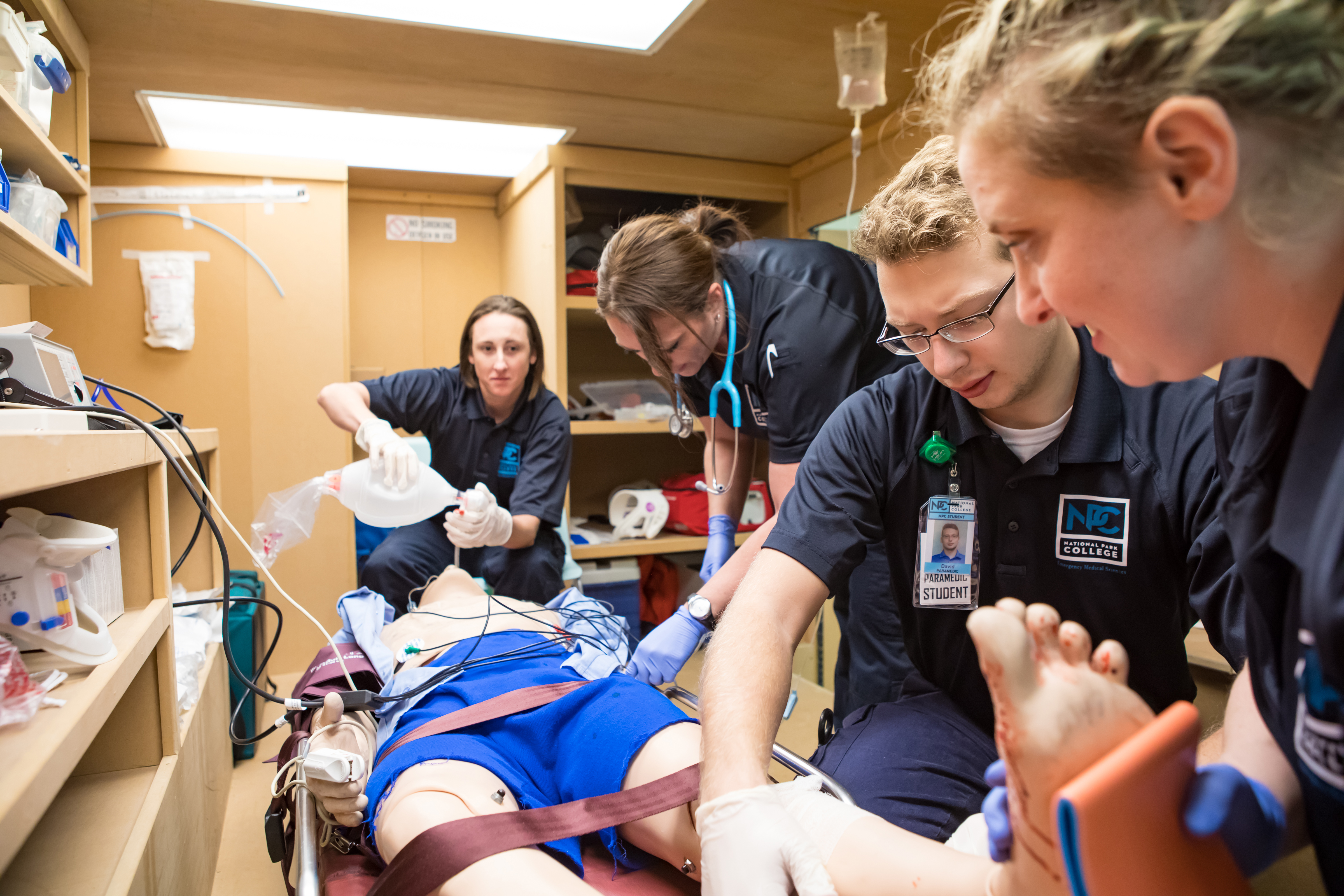 EMT students practicing on a dummy