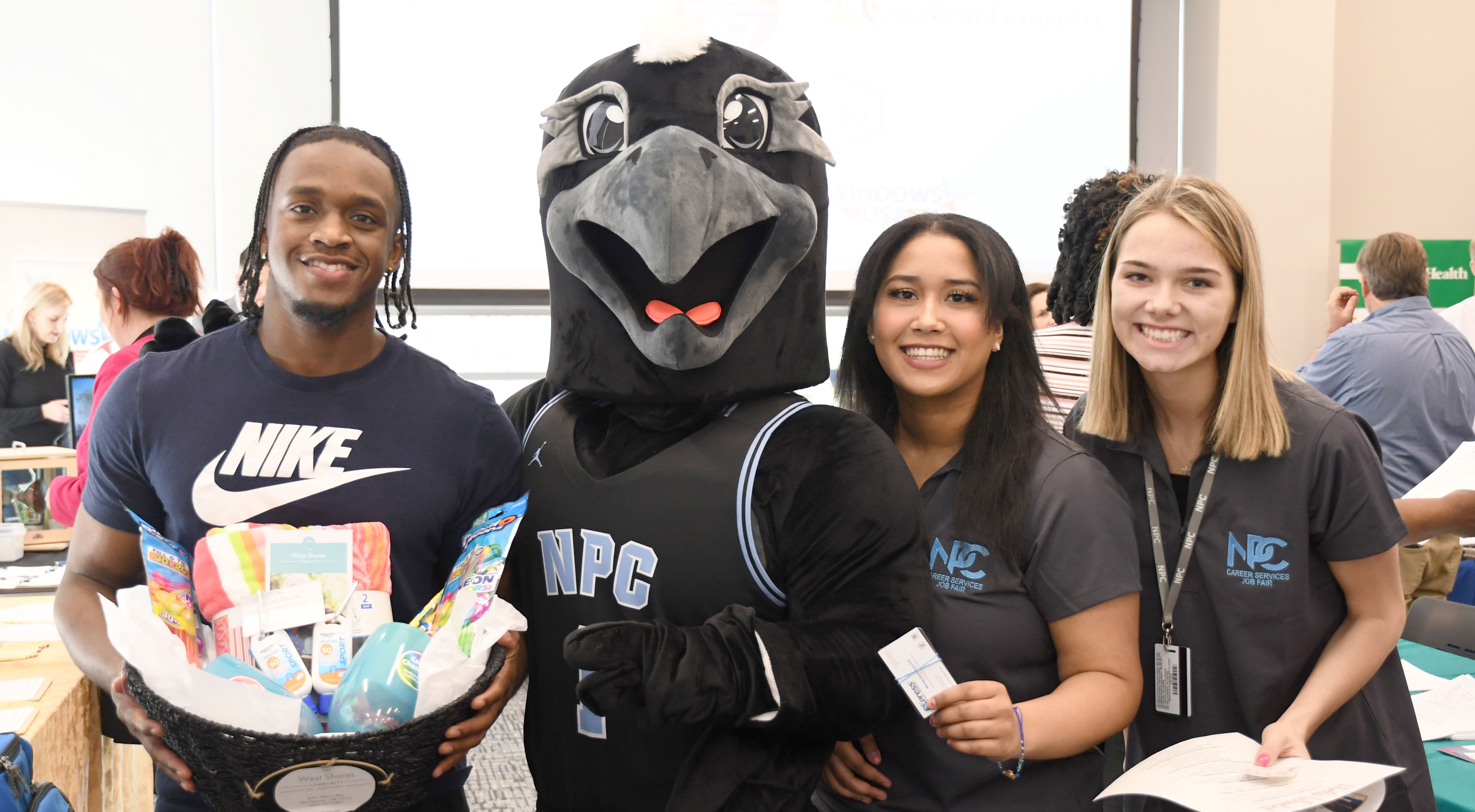 Students holding fair giveaways with mascot