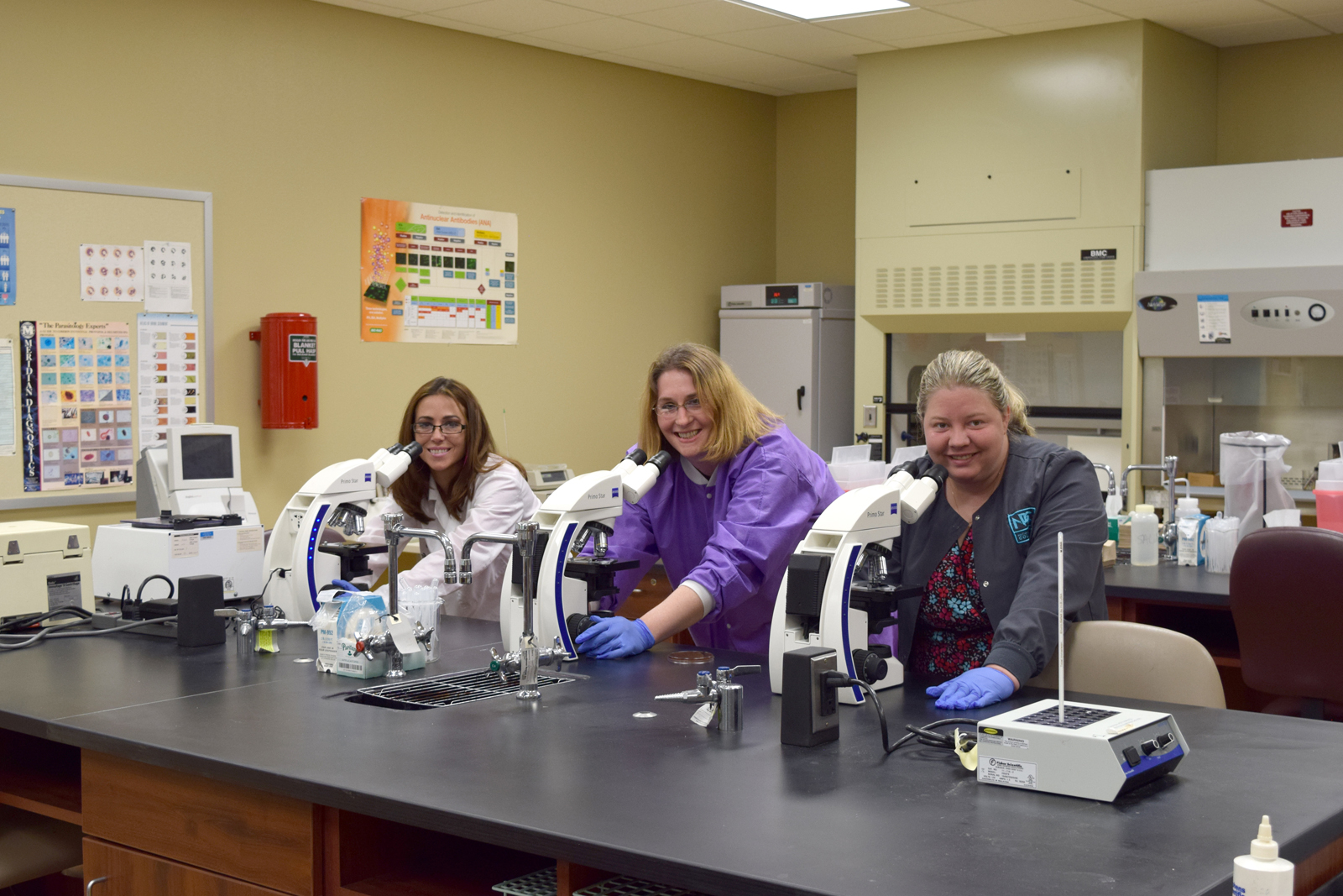 Three students working in lab