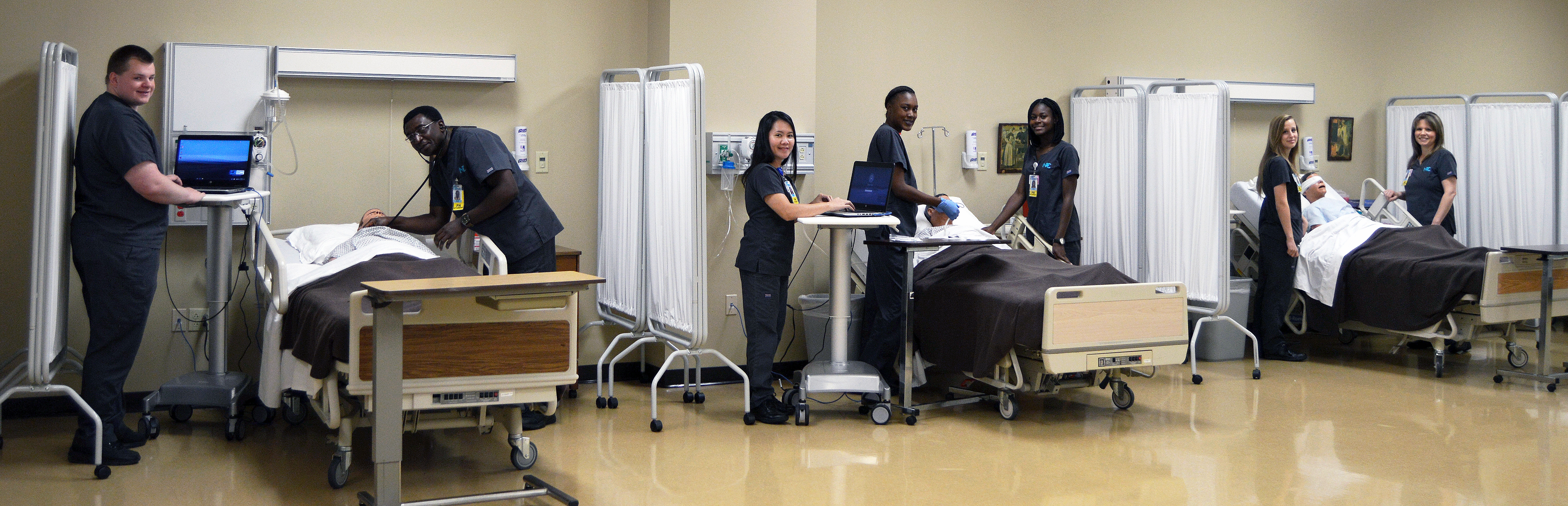 Nursing students in emergency room setup practicing on dummies