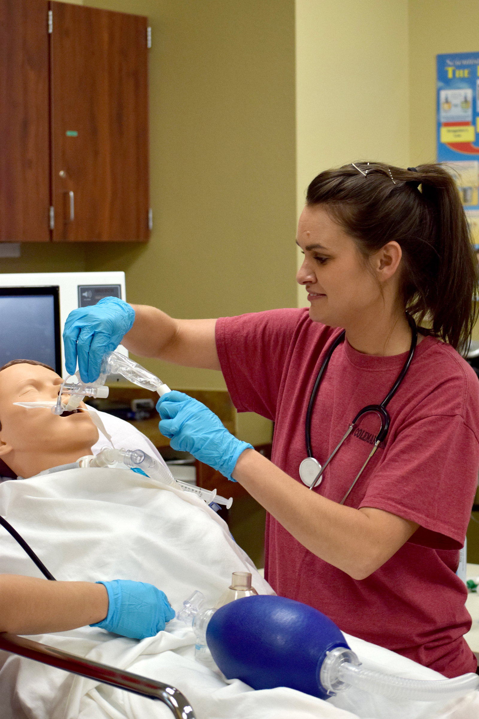 Student practicing giving oxygen to dummy patient