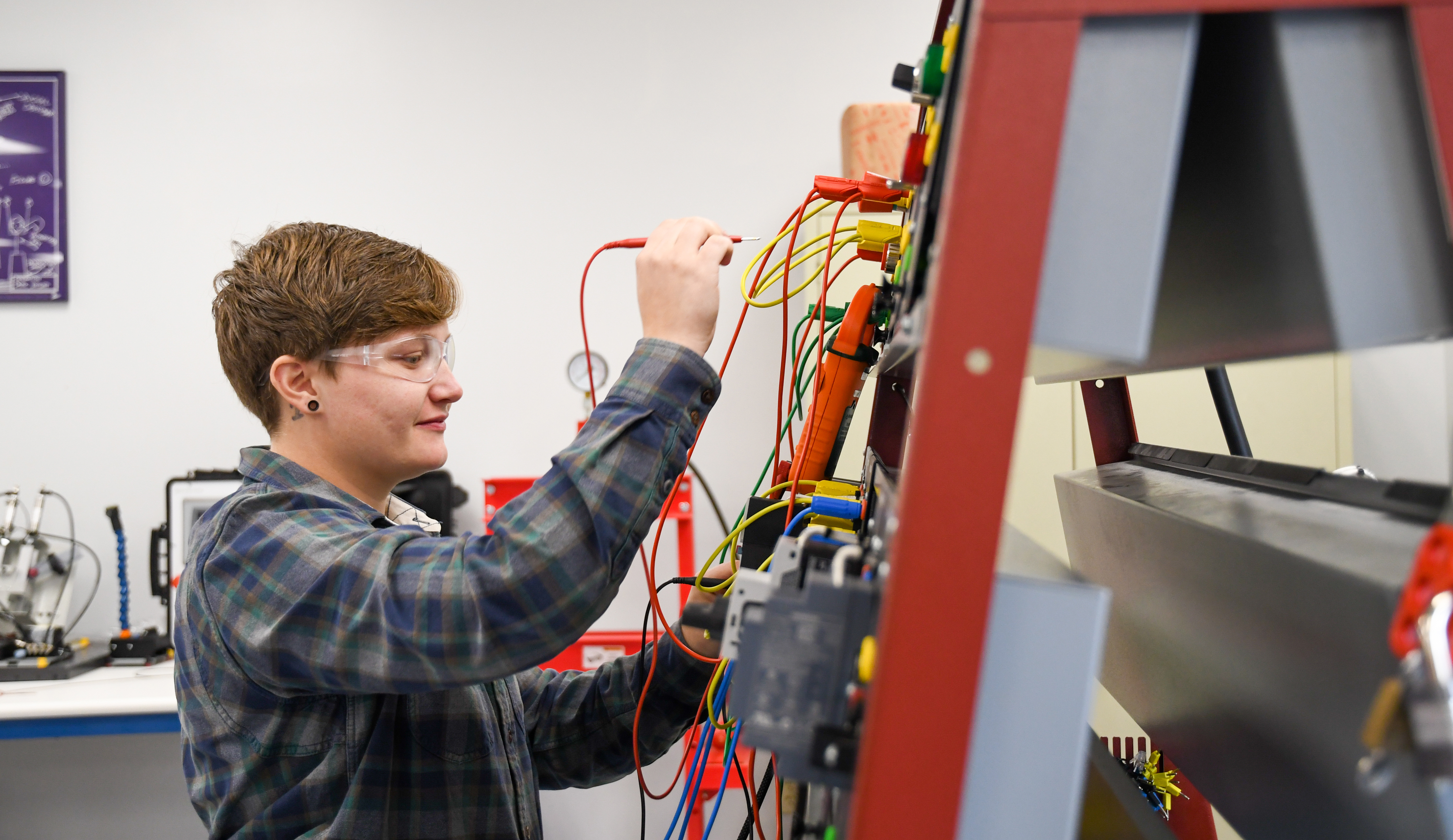 Student actively working with electrical wires