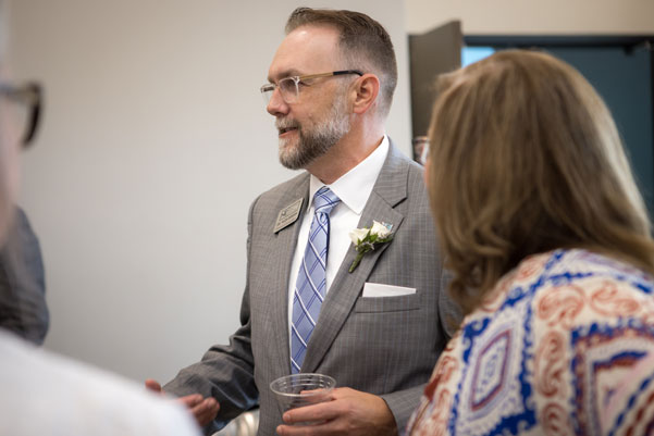 Dr. Wade Derden talking to people at a meet and greet.