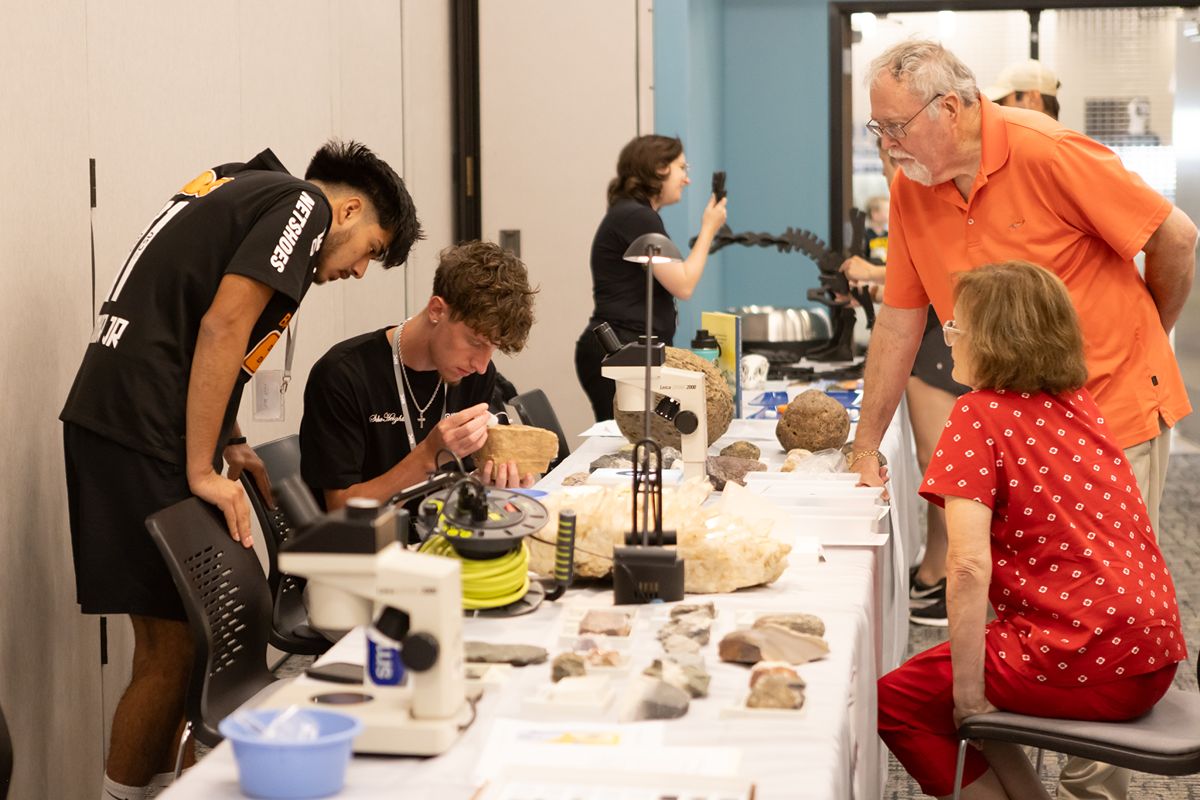 People gathered around a table with various items
