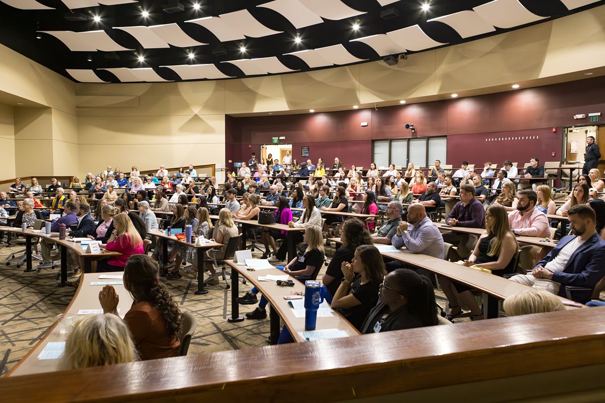 Large group of people seated in an auditorium