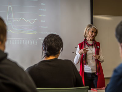 Teacher standing in front of class lecturing.