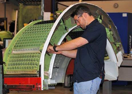 Triumph Airborne employee working on a thrust reverser