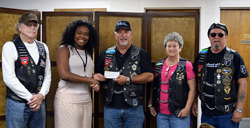 Scholarship recipient, Keanna Peck pictured with Harold Woody, Paul Calcagno, Linda and Mike Roberts from the Diamond Lakes Defender Law Enforcement Motorcycle Club.
