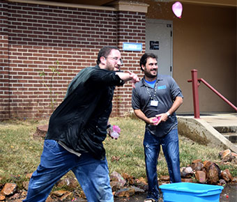 Students and faculty participate in water balloon fight after debate
