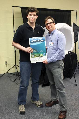 Andrew Gobel, Mountain Pine High School senior and Bill Solleder, Special Events Manager at Visit Hot Springs with the winning design.