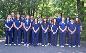 Medical Assistants standing in group photo in scrubs