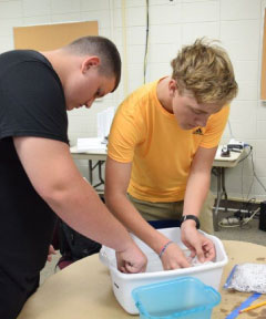 Two Lakeside pre-engineering students working on oil spill contaminant