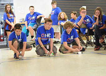 YMA participants preparing to race their teams' cars.