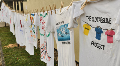 Shirts hanging from clothesline to represent domestic violence victims.