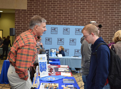 Pictured is Southern Arkansas University representative Steve Sutton (left) discussing transfer options with NPC student Keagan Furlong (right).