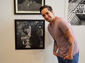Joe Pena showcasing a charcoal drawing he developed as part of Drawing II at National Park College
