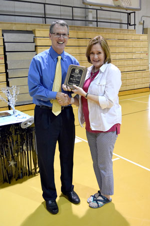 Mary Kay Wurm accepting her award for Outstanding Staff from NPC President, Dr. John Hogan.