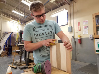 Wood Technology student sanding.