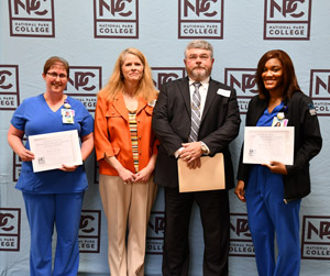 Pictured is David and Holly Hennessee (center) with scholarship recipients Raggan Wills (right) and Kelly Efurd (left).