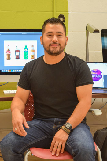 Julio Rodgriquez in front of his digital designs