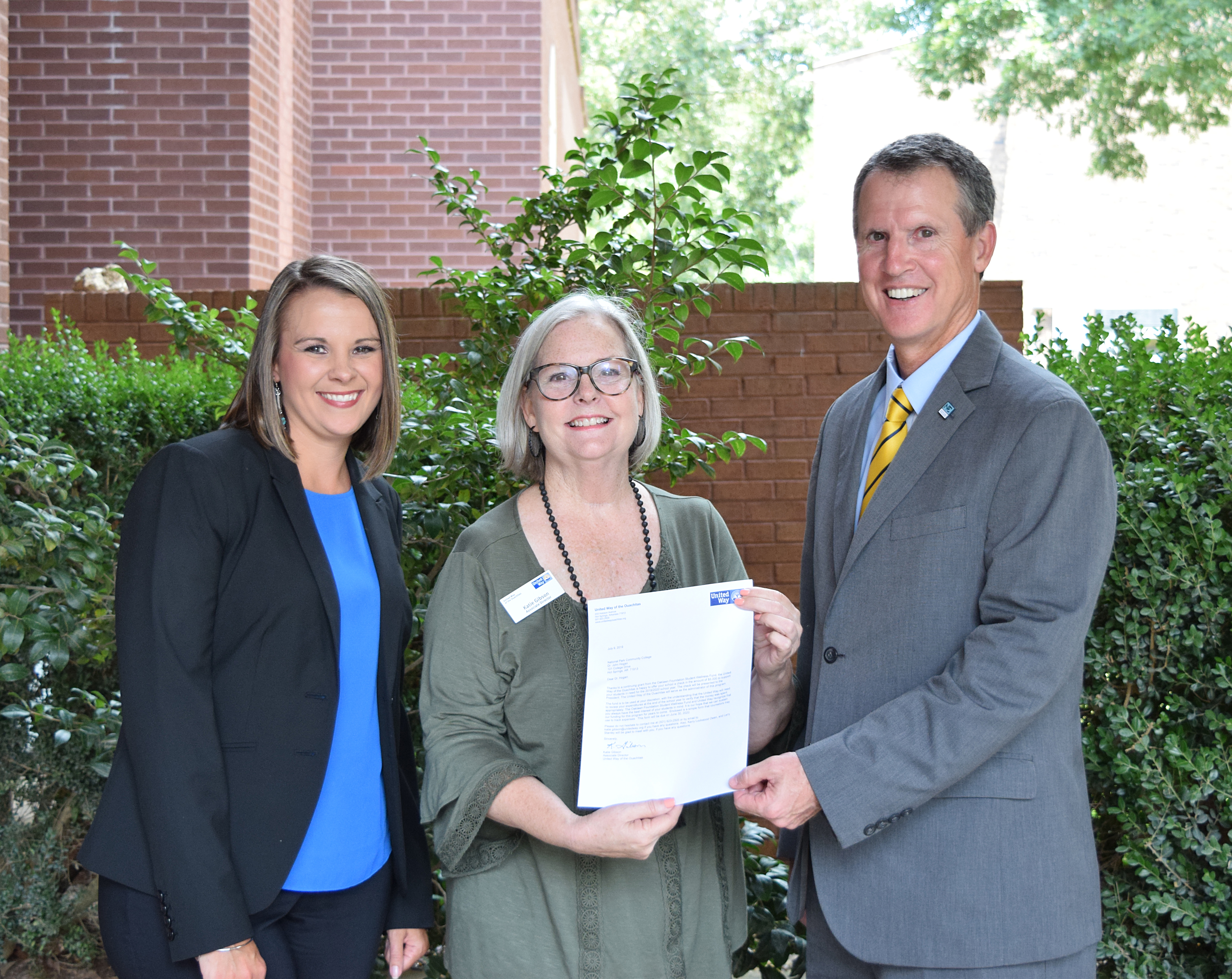 Nicole Herndon, Foundation Director, Dr. John Hogan, President of National Park College, receiving grant from Katie Gibson, Associate Director of the United Way of the Ouachitas.