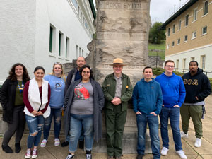 Honors student from NPC visit Hot Springs' National Park. They are standing in front of a monument in the National Park. 