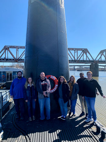 NPC Honors Program students standing on a submarine