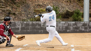Jesus Minjarez swinging the bat at the plate.