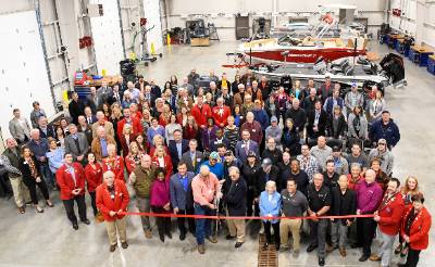 Aerial view of group attending ribbon cutting inside of the marine technology building.