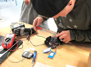 NPC student connecting the wiring to a prosthetic hand
