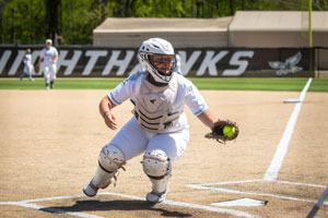 Catcher Baley Williams guarding home plate with ball in glove.