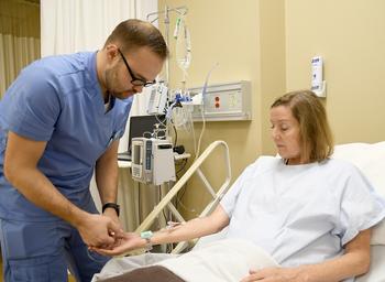 Nurse applying the IVY LOC device to a patient