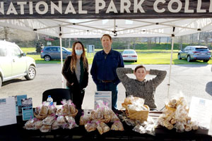 NPC students under pop-up tent selling snacks at the Farmer's Market.