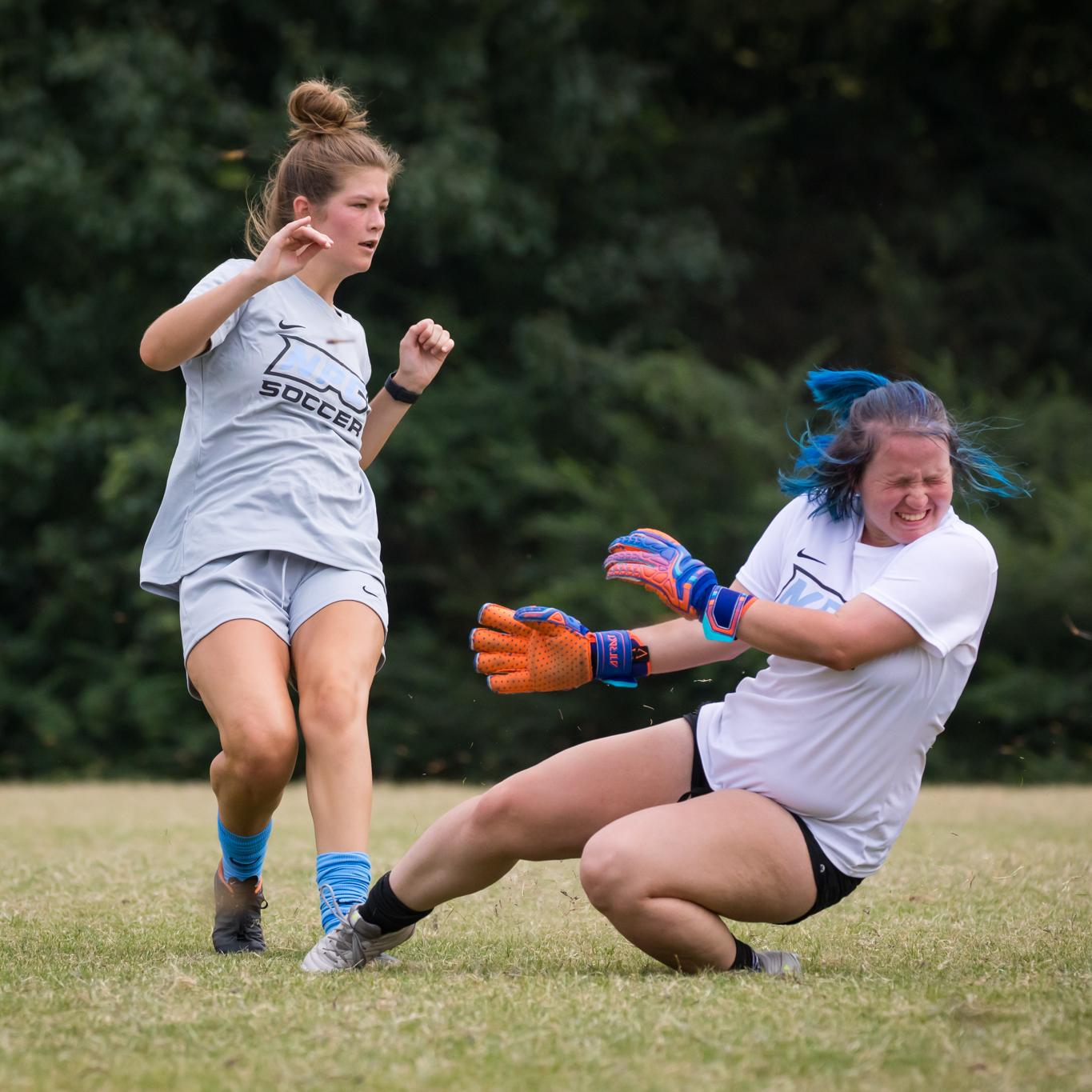 Women soccer players practicing on field. 