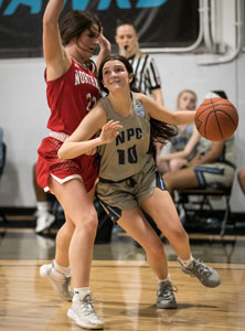 NPC's Kyra Hargrove dribbling basketball against defense.