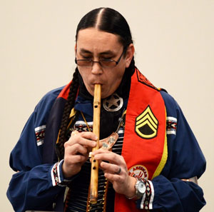 Native American Steven Morales playing a tradition flute.
