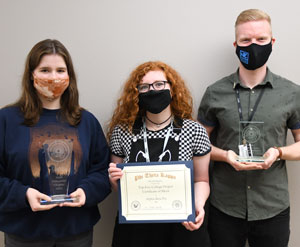 Three NPC students holding PTK awards.