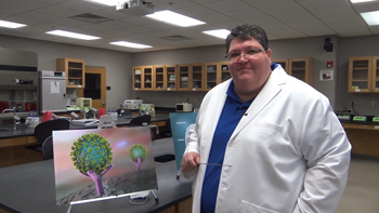 Dr. Rebekah Robinette standing in a science lab.