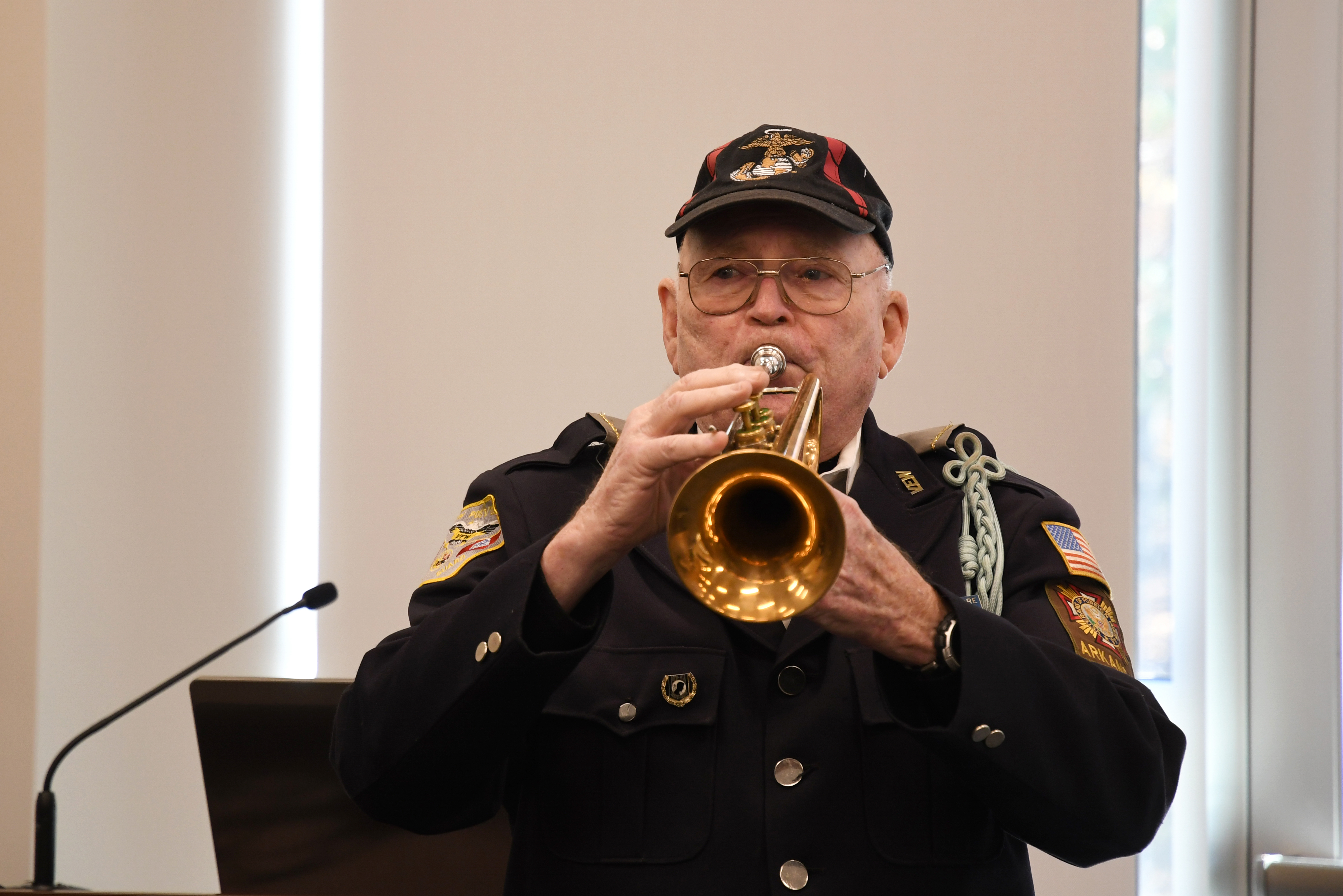 United States veteran playing the trumpet in dress blues. 