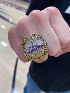 The hand of Seth Duke wearing his championship ring with the team name Eagles on it.