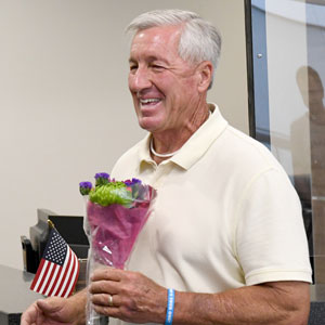 Lloyd Robertson holding flowers.