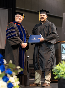 John Striednig on the graduation stage with Dr. David Lanoue, Provost and Vice President for Academic Affairs at SAU