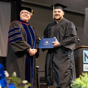 John Striednig on the graduation stage with Dr. David Lanoue, Provost and Vice President for Academic Affairs at SAU