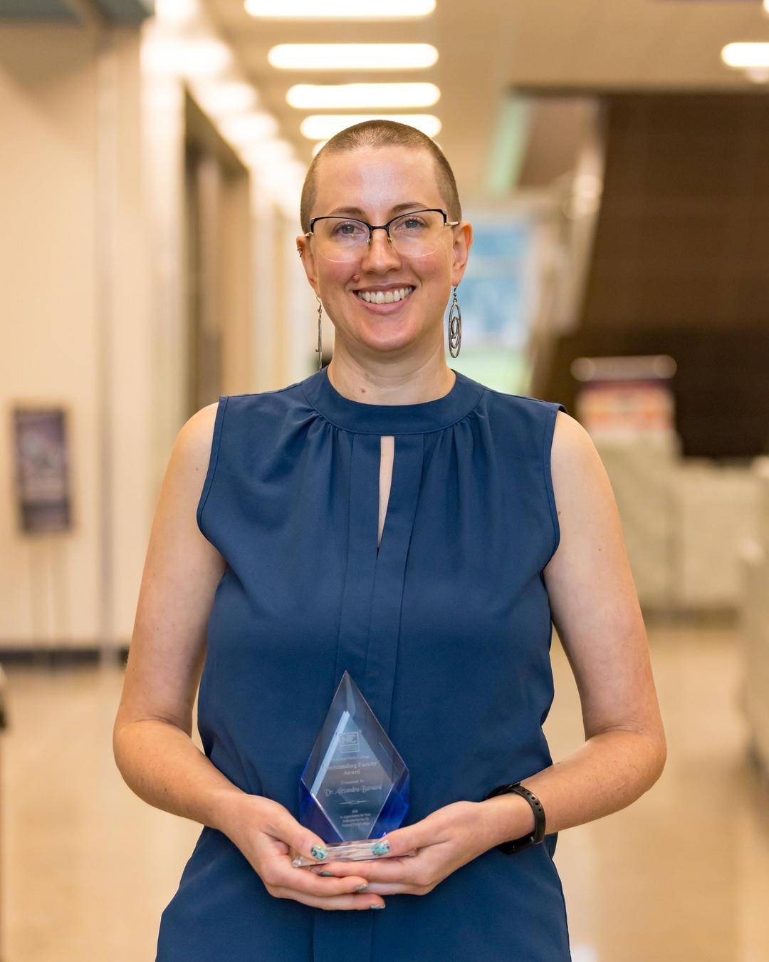 Alexandra Barnard holding the NPC outstanding faculty award