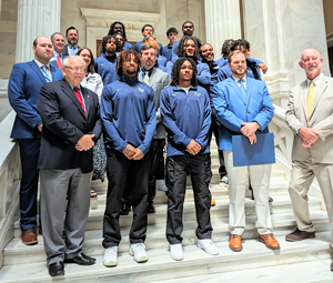 NPC men's basketball team, coaches, President Dr. Hogan, staff members and state representatives on the steps of the capitol building.