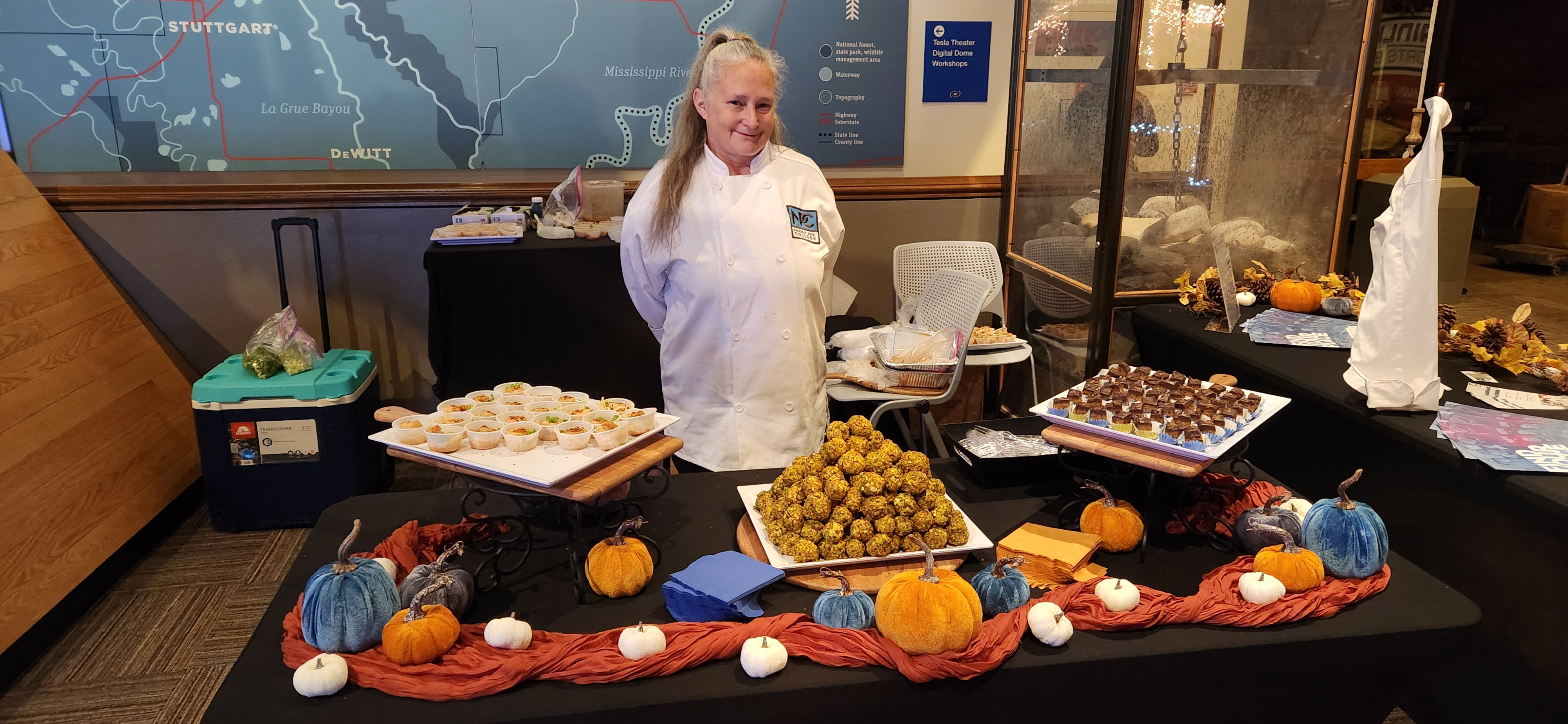 chef in front of ornate display of food