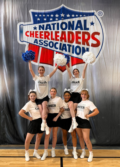 Cheerleaders doing a pyramid.